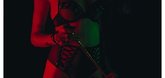 donna in lingerie con frustino bdsm