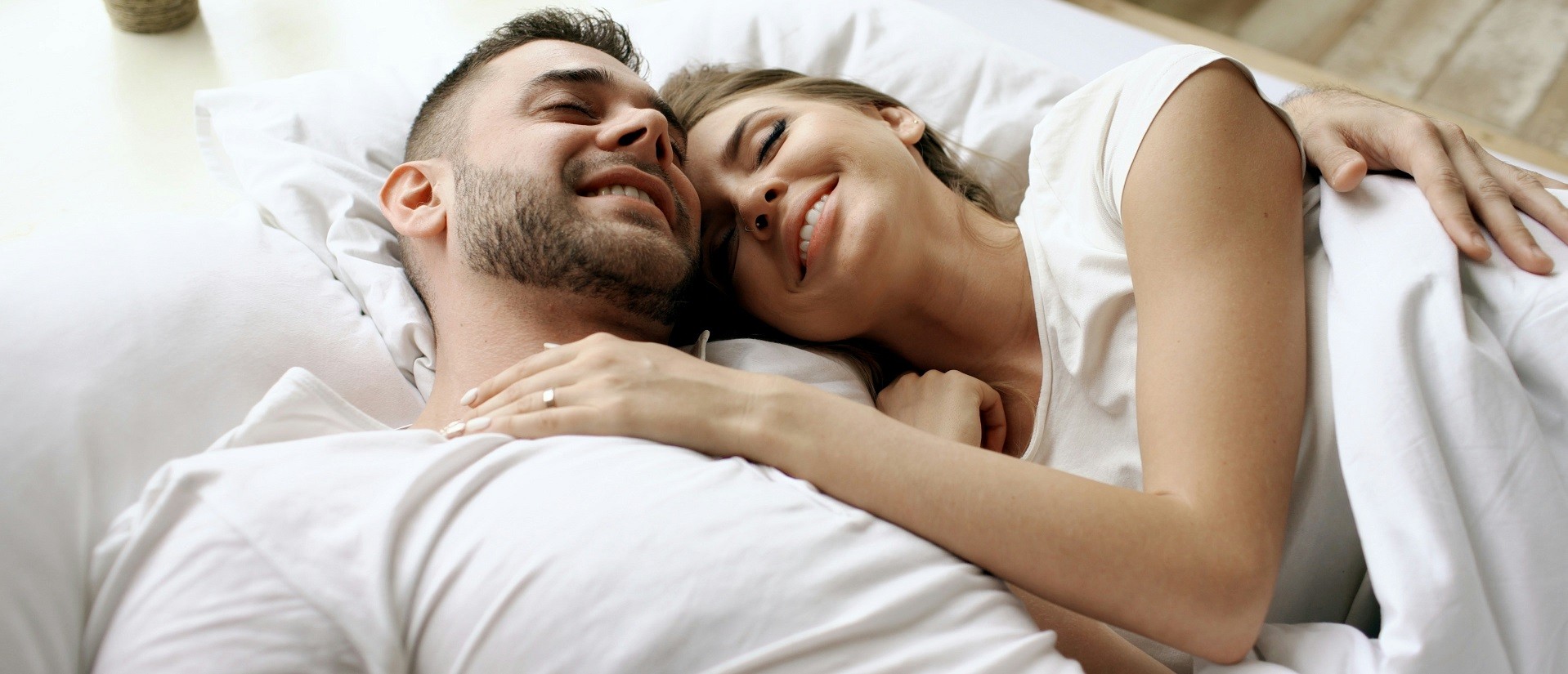 happy couple in bed